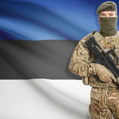 Soldier with machine gun and flag on background - Estonia