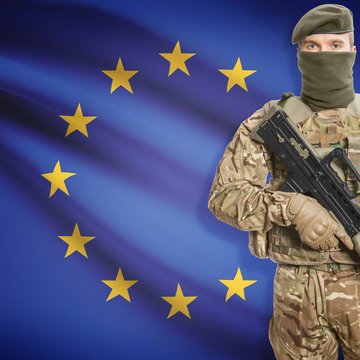 Soldier with machine gun and flag on background - European Union - EU