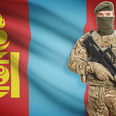 Fototapeta premium Soldier with machine gun and flag on background - Mongolia