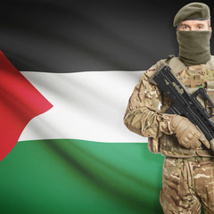 Soldier with machine gun and flag on background - Palestine