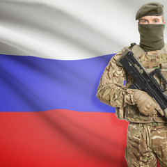 Soldier with machine gun and flag on background - Russia