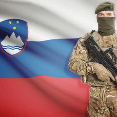 Soldier with machine gun and flag on background - Slovenia