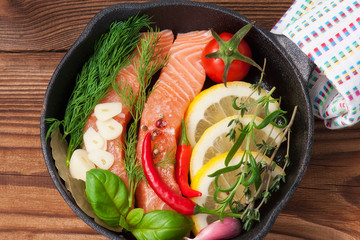 salmon steaks with herbs on rustic pan, diet concept