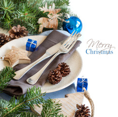 Blue and brown Christmas table setting with rustic decorations