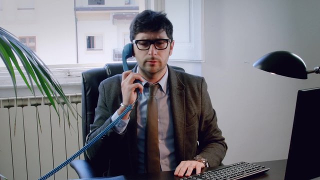 Italian Business Man Or Lawyer Talking On The Phone In His Office. He Gets Angry. 