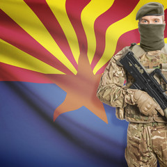 Soldier with machine gun and USA state flag on background - Arizona
