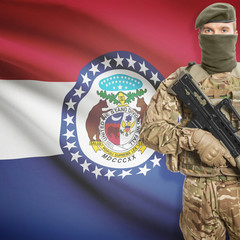 Soldier with machine gun and USA state flag on background - Missouri