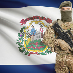 Soldier with machine gun and USA state flag on background - West Virginia