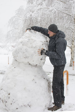 Tall Man Making Really Tall Snowman