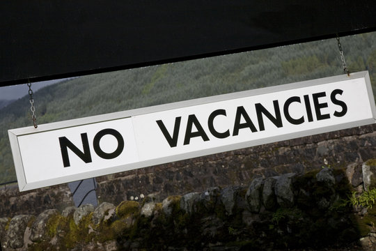 No Vacancies Sign outside Hotel in Rural Setting