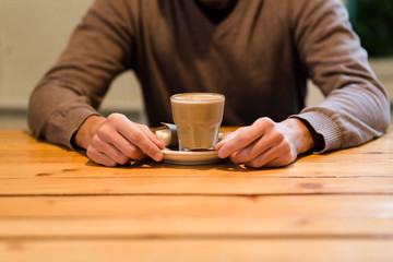 Fototapeta na wymiar male hands with cup of coffee