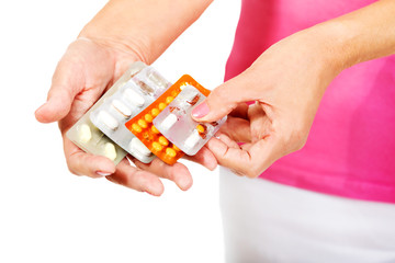 Senior woman holding few tablets package