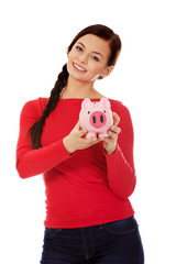 Happy young student woman holding piggybank