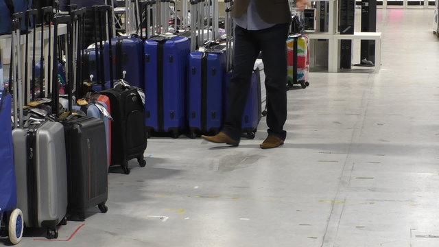 People walking around luggage suitcase selection at the department store