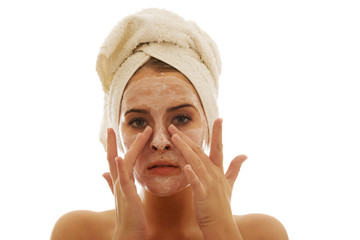 Woman applying a cream on her face