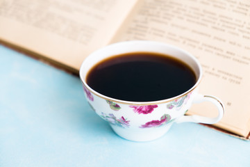 cup of hot coffee and open book 