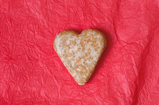 gingerbread heart cookie on red background