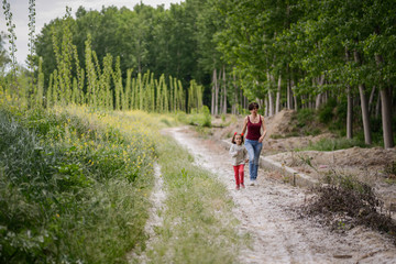 Obraz premium Mother with her little daughter in poppy field