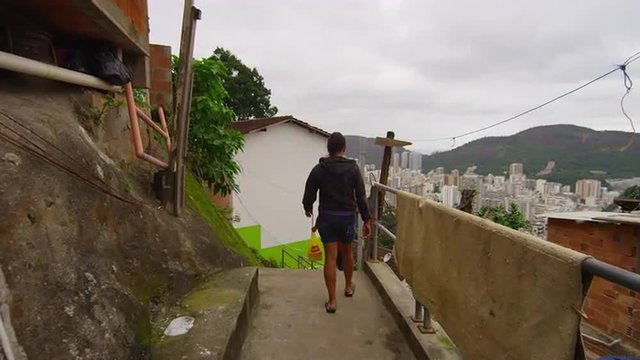Slow dolly shot of walking kids in a favela on June 23, 2013 in Rio de Janeiro, Brazil
