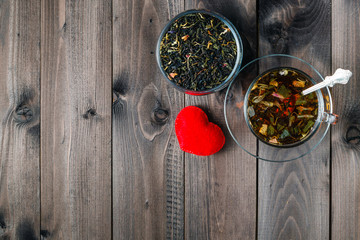 Hot herbal tea on dark aged wooden background