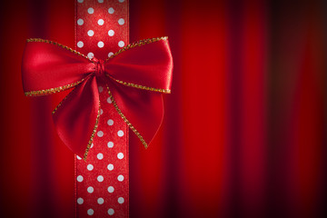 Red bow and ribbon on abstract background