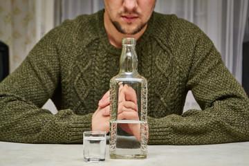 The guy in the green sweater wants to think about drinking alcohol.