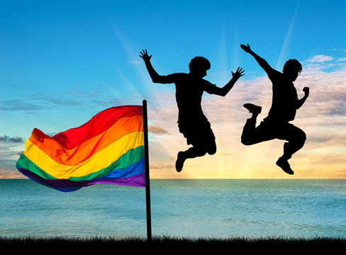 Silhouette of two happy gays jump