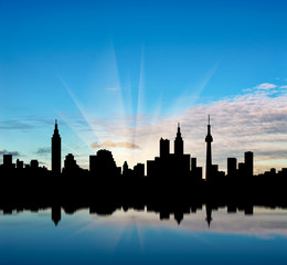 Obraz premium Cityscape silhouette on a background of beautiful sunrise