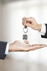 Estate Agent giving key to the owner 