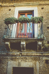 Vintage Window with a Balcony of an Old House. Vintage Filter Applied. Shallow Deep of Field.