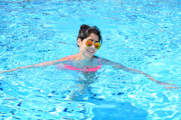young beautiful  woman swimming in a pool .Summer holiday
