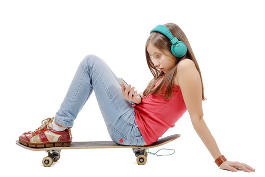  pretty young girl posing with a skateboard, sitting on skate, l