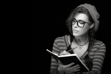 Pretty College Girl in Trendy Clothing Writing on her Notebook