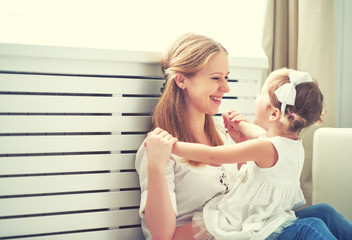 Happy loving family. mother and child playing,  kissing and hugg