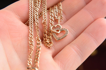 gold pendant in the shape of a heart on a Valentine's Day gift