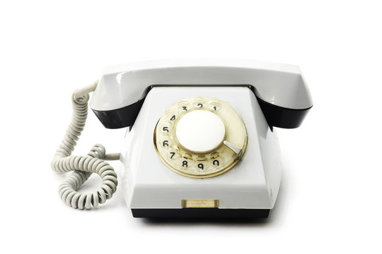 Old white telephone on white background