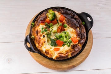 Fresh ham and cheese omelet in fry pan