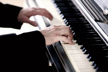 Close up of man hands piano playing