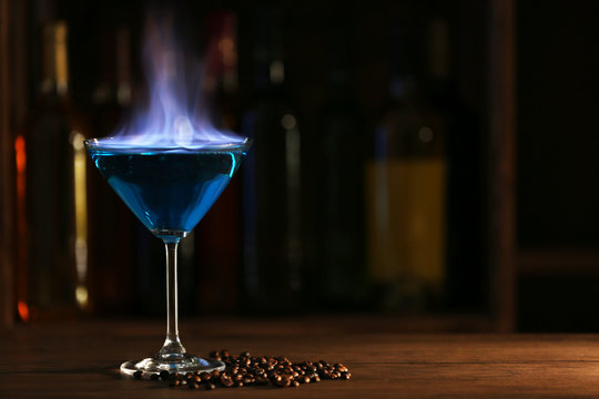 Burning cocktail on table in a bar