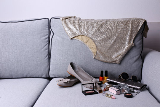 Composition of woman's fashion look on a gray couch