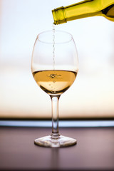 Pouring a glass of wine.
