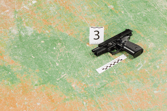 murder gun lying on the floor. crime scene