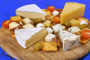 Cheese for tasting on cutting board
