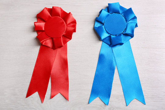 Award ribbons on wooden background