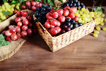 Grape in wicker box on table closeup