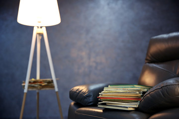 Pile of books on leather chair in the room, close up