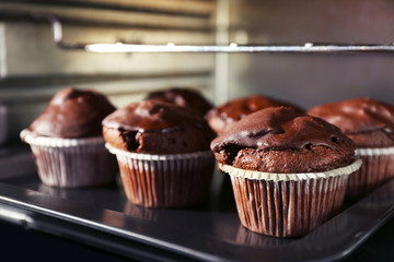 Chocolate cup-cakes in oven, close up