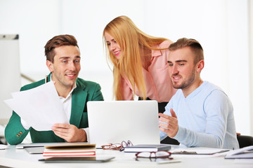 Fototapeta premium Young business people discussing a new project at the meeting in a conference room
