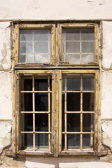 Fototapeta na wymiar Windows with bars in an abandoned house