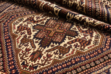 Close up of a persian afshar oriental carpet with peacock motif
